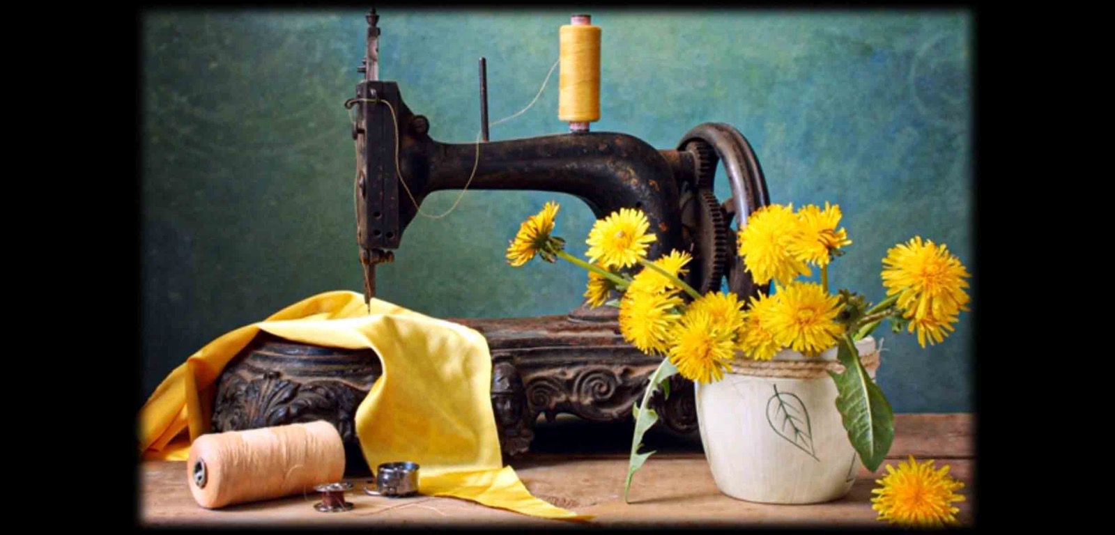 Vintage sewing machine with yellow thread and flowers